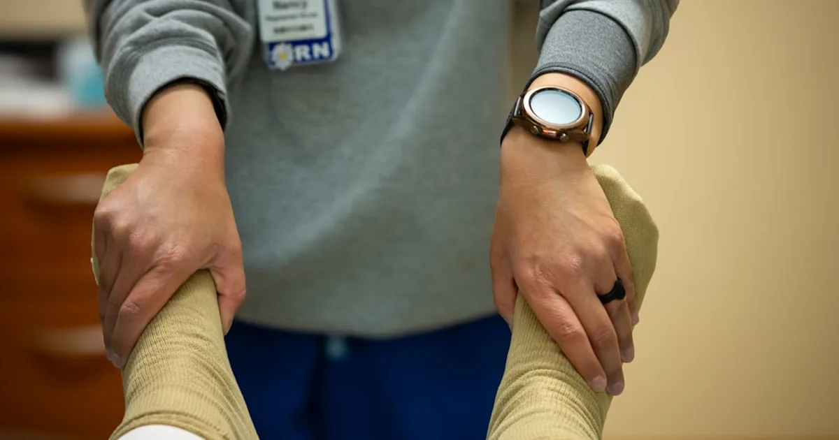 A nurse is performing physical therapy.