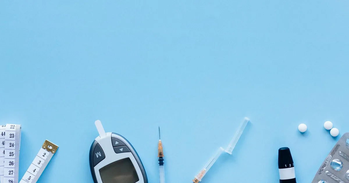 Glucometer, syringe, and medications illustrating diabetes treatment